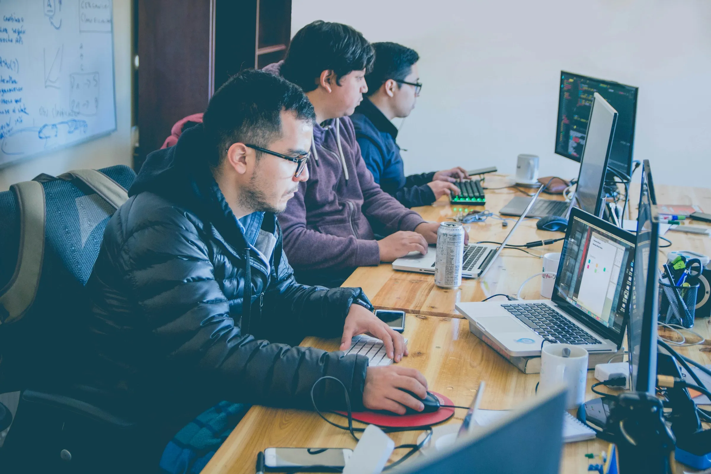 Developers working through a problem together at their desks